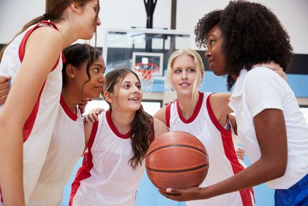 Female,High,School,Basketball,Players,In,Huddle,Having,Team,Talk
